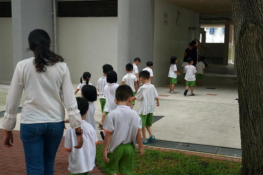 Pre-school children from "My First Skool", a childcare arm of NTUC First Campus Co-operative Limited, being lead by their teacher near a block of HDB flats in Toa Payoh. About 17,000 childcare places have been added over the past two years, said Mini