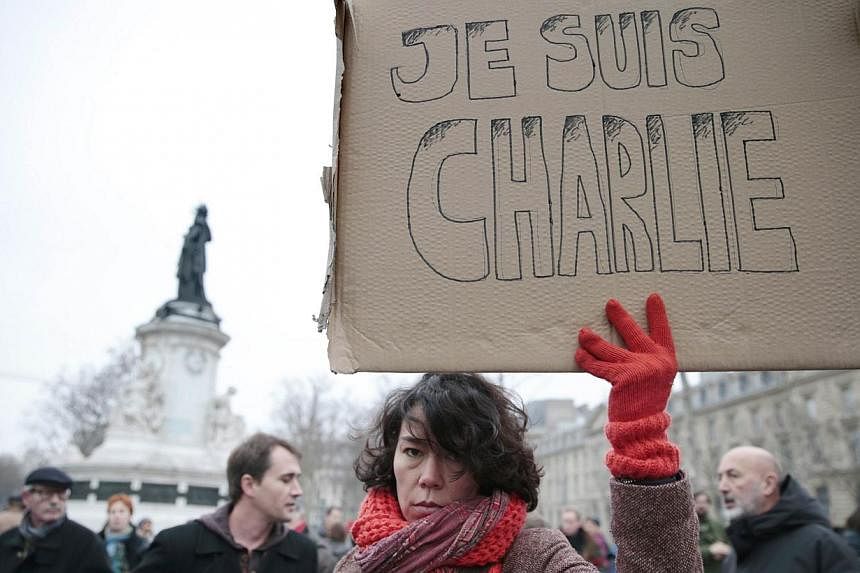 A woman holds up a placard that reads in French, "I am Charlie" at a gathering in Paris on Jan 7, 2015, following Islamist attacks on the French capital. Paris City Hall on Wednesday decided to launch a lawsuit over reports by US news channel Fox New