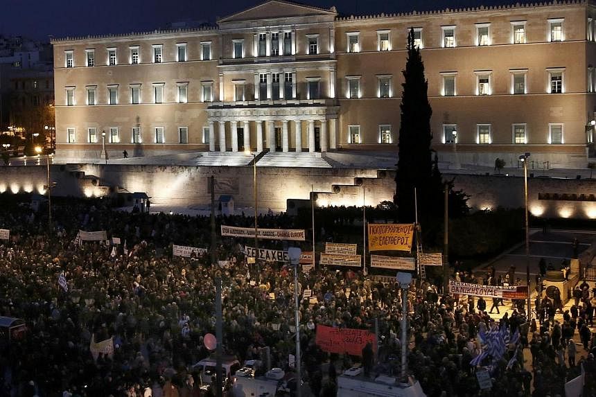 People gather for an anti-austerity, pro-government demonstration outside the Greek parliament in Athens on the eve of a crucial euro zone finance minister's meeting to discuss the country's future, on Feb 11, 2015. -- PHOTO: REUTERS&nbsp;