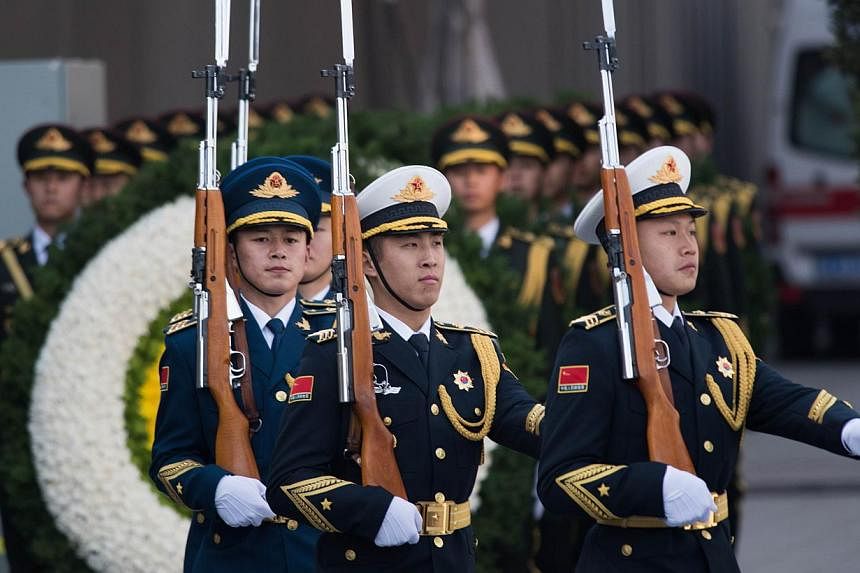 People's Liberation Army soldiers at a memorial ceremony for Nanjing Massacre victims in Nanjing city, Jiangsu province, on Dec 13, 2014. -- PHOTO: AFP