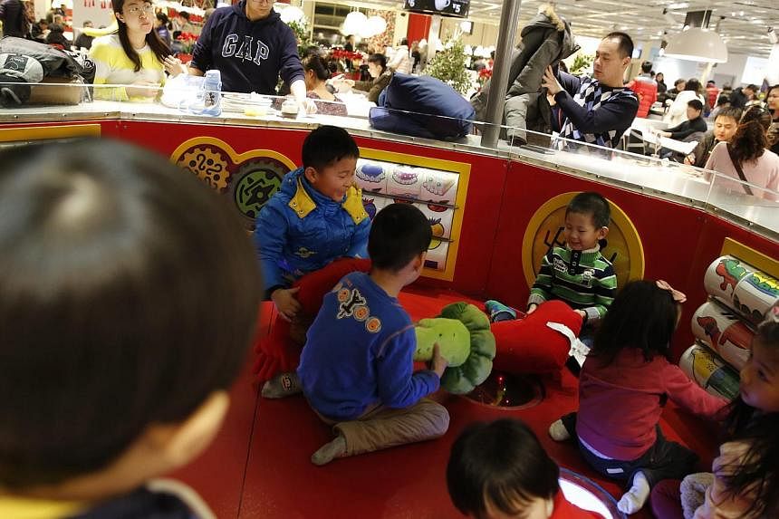 Children playing at a furniture shop in Beijing on Feb 3, 2015. -- PHOTO: EPA