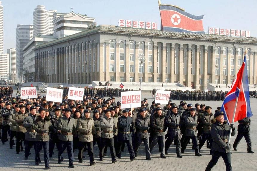 A picture released by the North Korean Central News Agency on Feb 9, 2015, shows North Korean men marching at Kim Il-Sung Square in Pyongyang, on Feb 8, 2015, to celebrate the 67th anniversary of the North's regular armed forces. -- PHOTO: EPA
