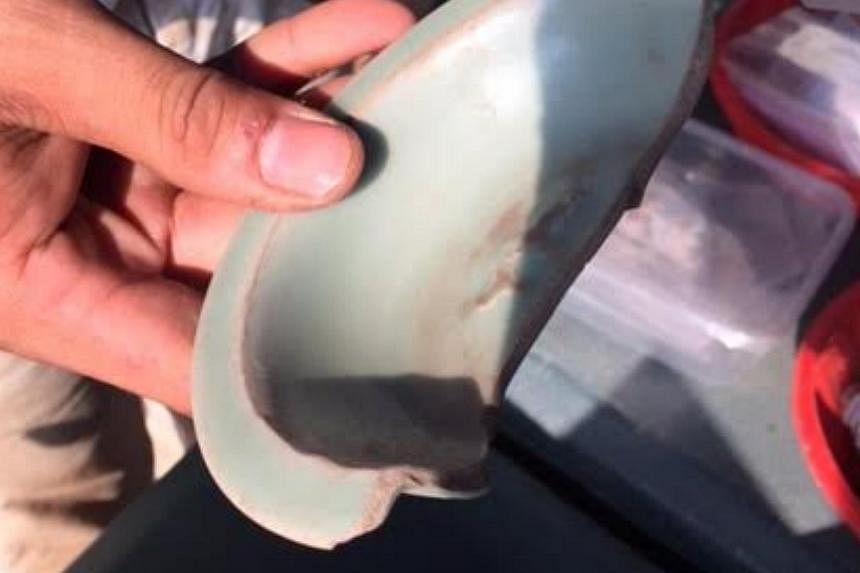 A celadon bowl with a fish motif that is 700 years old.&nbsp;-- ST PHOTO: MELODY ZACCHEUS