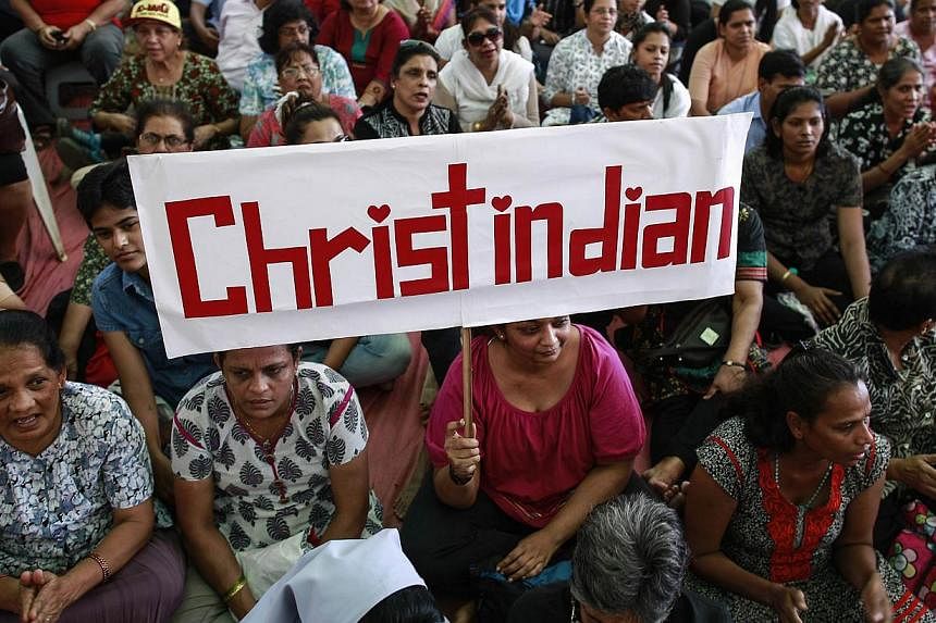 A protester holds a placard during a rally by hundreds of Christians against recent attacks on churches nationwide, in Mumbai on Feb 9, 2015. Prime Minister Narendra Modi summoned New Delhi's police commissioner on Friday after the latest attack on a