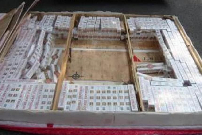 A stash of duty-unpaid cigarettes worth an estimated $104,000 was uncovered in a routine check on a Singapore-registered lorry at Keppel Distripark.&nbsp;--PHOTO: IMMIGRATION &amp; CHECKPOINTS AUTHORITY