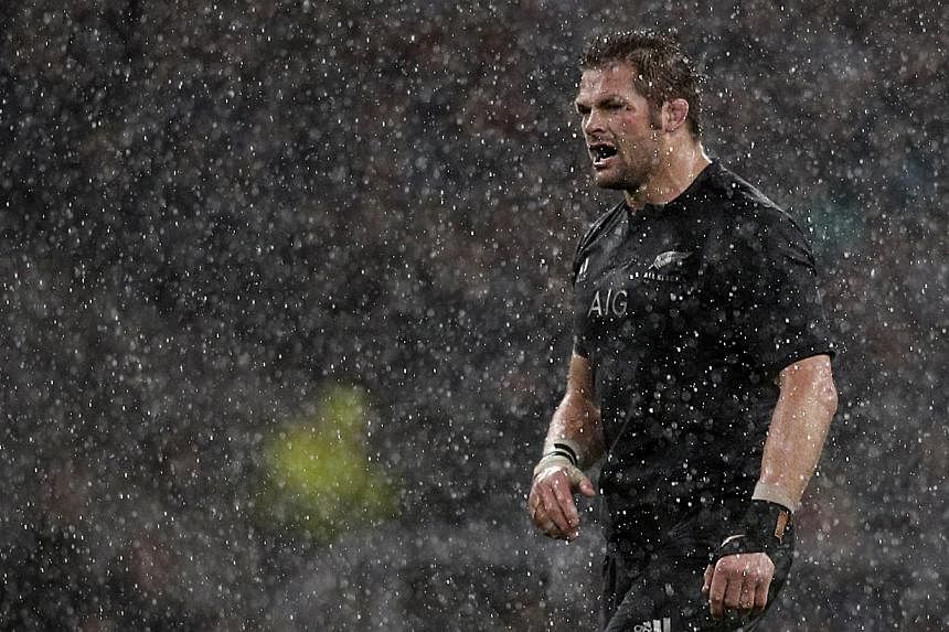 New Zealand's Captain Richie McCaw looks back at his teammates through the rain during the Autumn international rugby union Test match between England and New Zealand at Twickenham Stadium, southwest of London on Nov 8, 2014. -- PHOTO: AFP