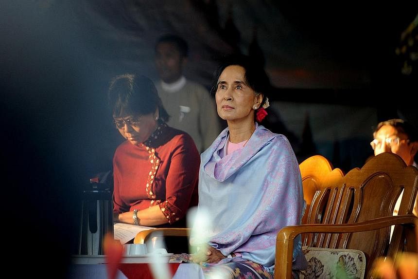 Myanmar opposition leader Aung San Suu Kyi (centre) attending a ceremony to mark the 100th birthday of her father, independence hero Aung San, in the remote central Myanmar town of Natmauk on Feb 13, 2015. -- PHOTO: AFP&nbsp;
