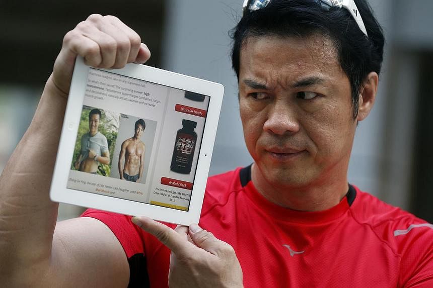 Local actor Zheng Geping holding up an iPad showing a website which has used photos showing his chiselled torso to publicise some health supplements without his permission. At least one person has complained of problems after taking the muscle-buildi