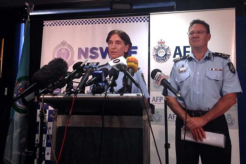 Australian Federal Police Deputy Commissioner Michael Phelan (right) listens as New South Wales Deputy Police Commissioner Catherine Burn speaks during a media conference in Sydney on&nbsp;Feb 11, 2015. The police and a prayer hall were among potenti
