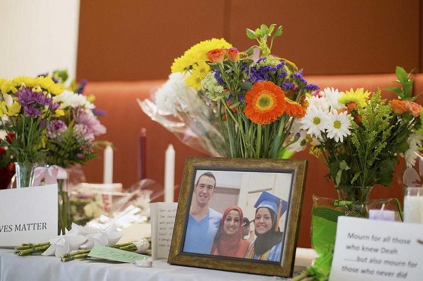 A makeshift memorial for Mr Deah Shaddy Barakat, his wife Yusor Mohammad and Yusor's sister Razan Mohammad Abu-Salha, who were killed by a gunman, is pictured inside of the University of North Carolina School of Dentistry, in Chapel Hill, North Carol