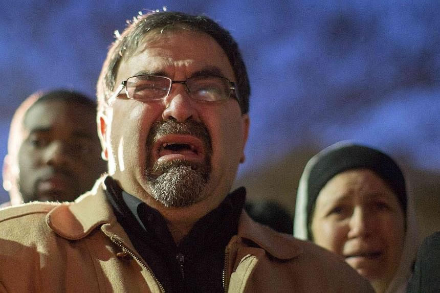 Namee Barakat, father of shooting victim Deah Shaddy Barakat, cries as a video is played during a vigil on the campus of the University of North Carolina in Chapel Hill, North Carolina Feb 11, 2015. -- PHOTO: REUTERS