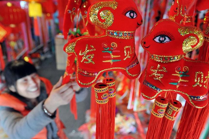 A customer buying decorations for the upcoming Lunar New Year in Lin'an, Zhejiang province, on Feb 12, 2015. -- PHOTO: AFP