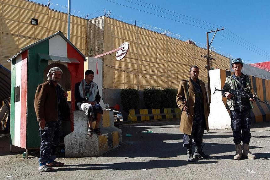 Yemeni security forces stand guard outside the Italian embassy in Sanaa on Feb 13, 2015. Saudi Arabia, Germany and Italy became the latest countries to withdraw embassy staff from Yemen on Friday as an exodus of foreign diplomats gathered pace due to