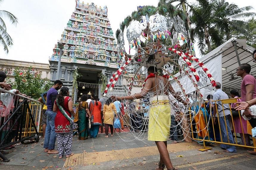 Devotees in a procession before entering Sri Thendayuthapani Temple - the end point - on Tank Road. -- ST PHOTO: ONG WEE JIN
