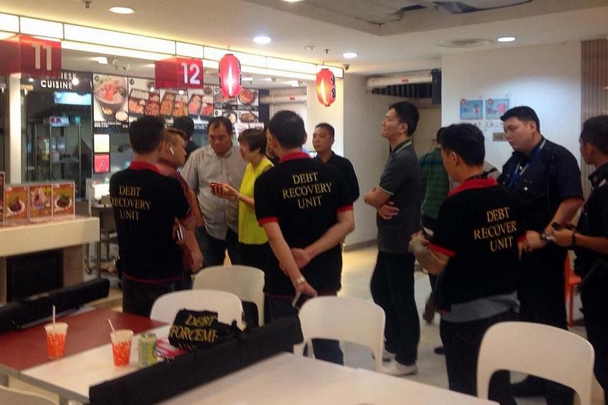 Debt collectors from Double Ace Associates caused a ruckus at a Chinese soup stall in the Food Junction foodcourt at Funan DigitaLife Mall on Jan 15, 2015. Seven men, aged between 35 and 48, have been arrested for their suspected involvement in a cas