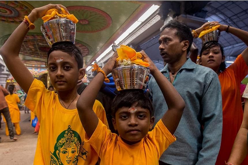 Young children carrying palkudam during the Thaipusam procession on Jan 17, 2014.&nbsp;The Ministry of Manpower (MOM) has issued a response on whether Thaipusam should be reinstated as a public holiday. -- PHOTO:&nbsp;TAMIL MURASU