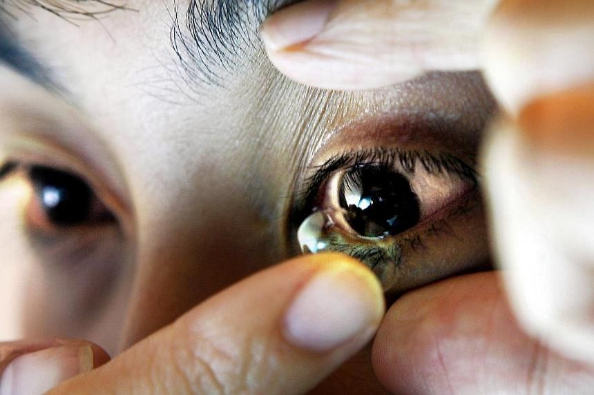 Swiss researchers are developing contact lenses that contain tiny telescopes to boost vision and zoom in and out with the wink of an eye, researchers said on Friday. -- PHOTO: THE NEW PAPER FILE