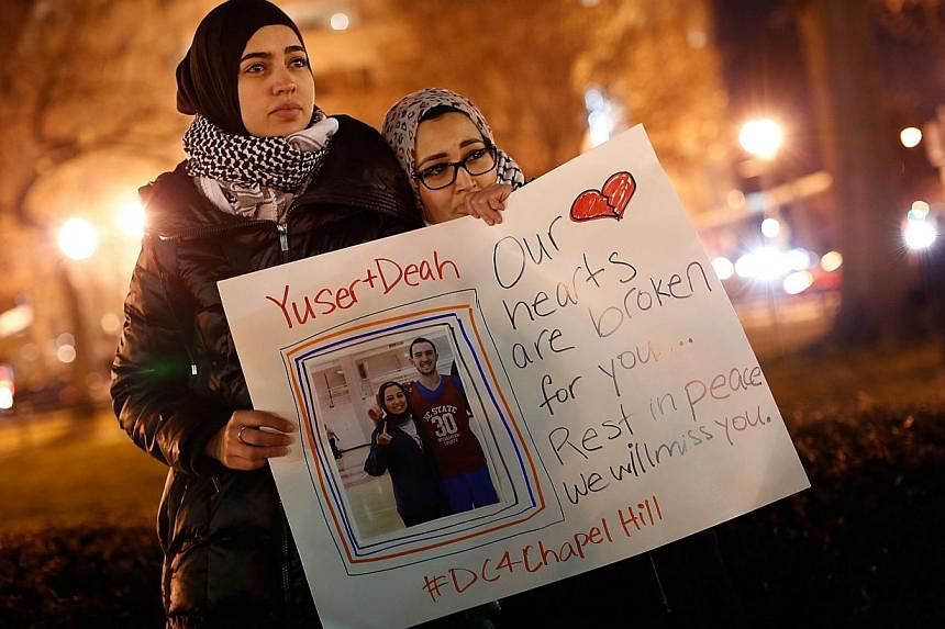 Kheira Benkreira (left) and Hasnia Bekkadja attend a vigil held by the Council on American-Islamic Relations in Dupont Circle in Washington, DC on Feb 12, 2015. -- PHOTO: AFP