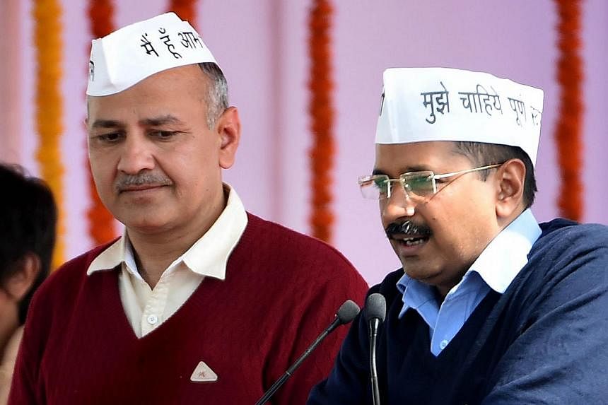 Aam Aadmi Party (AAP) president Arvind Kejriwal (right), with fellow AAP minister Manish Sisodia, addressing supporters during his swearing-in ceremony as Delhi chief minister in New Delhi on Feb 14, 2015. -- PHOTO: AFP