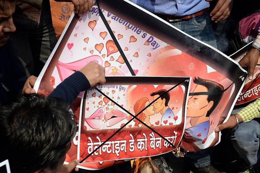 Activists of right-wing Hindu organisation Hindu Sena shouting anti-Valentine's Day slogans as they prepare to burn placards during a protest in New Delhi on Feb 12, 2015. -- PHOTO: AFP