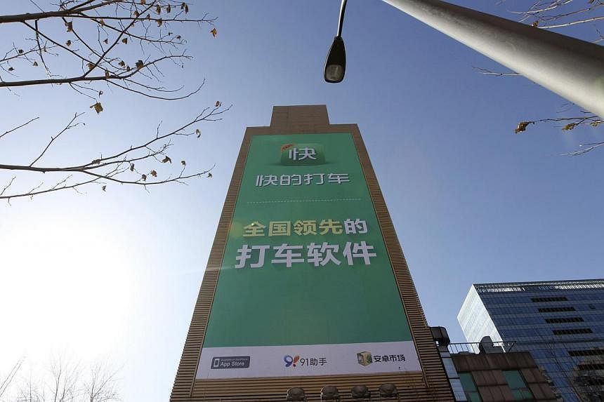A Kuaidi Dache advertisement in Beijing. The app and Didi Dache together control 99 per cent of China's domestic market for booking taxis by smartphone. -- PHOTO: REUTERS
