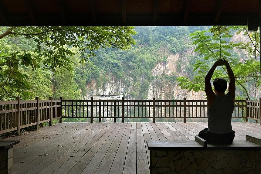 A jogger taking a rest at the Kruing Hut which overlooks the Hindhede Quarry at Bukit Timah Nature Reserve. -- ST PHOTO: KUA CHEE SIONG
