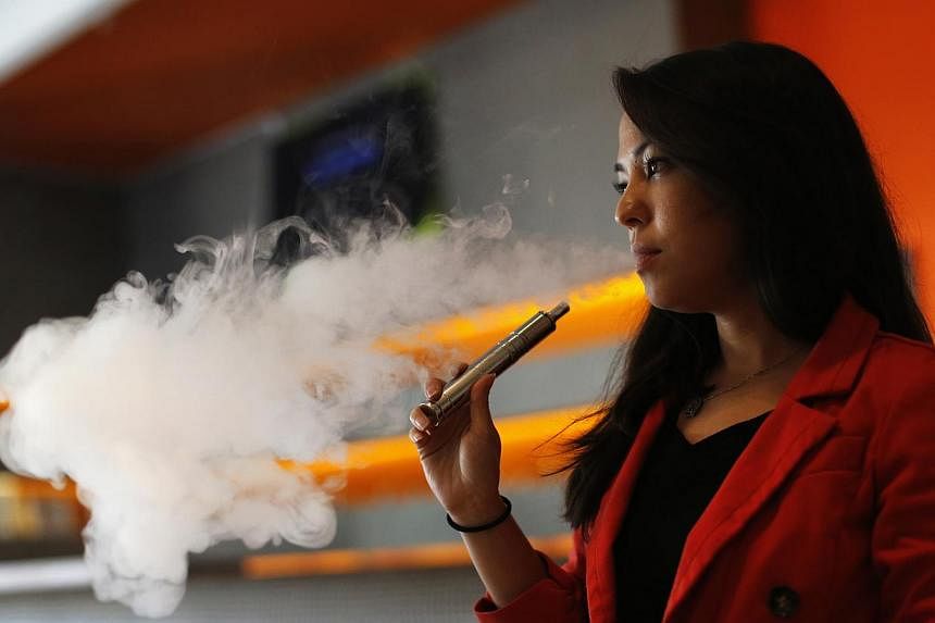 Enthusiast Brandy Tseu using an electronic cigarette at The Vapor Spot vapor bar in Los Angeles, California in this March 4, 2014 file photo.&nbsp;E-cigarettes can be an effective tool for smokers aiming to kick their tobacco habit, but officials fea