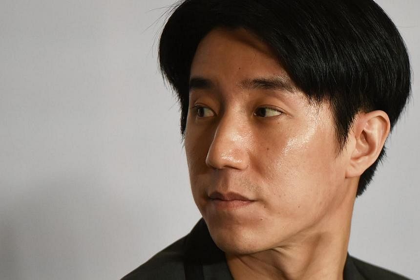 Jaycee Chan, the son of Hong Kong actor Jackie Chan, looking towards the exit near the end of a press conference in Beijing on Feb 14, 2015 following his release from jail.&nbsp;&nbsp;-- PHOTO: AFP