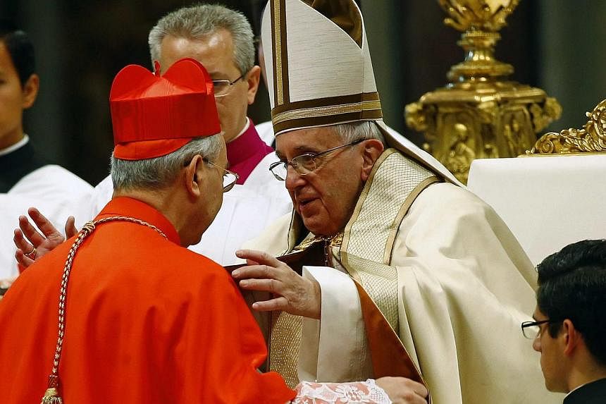 Pope Francis (right) embracing newly elevated cardinal Dominique Mamberti during a mass to create 20 new cardinalsat a ceremony in St. Peter's Basilica at the Vatican on Feb 14, 2015. -- PHOTO: REUTERS