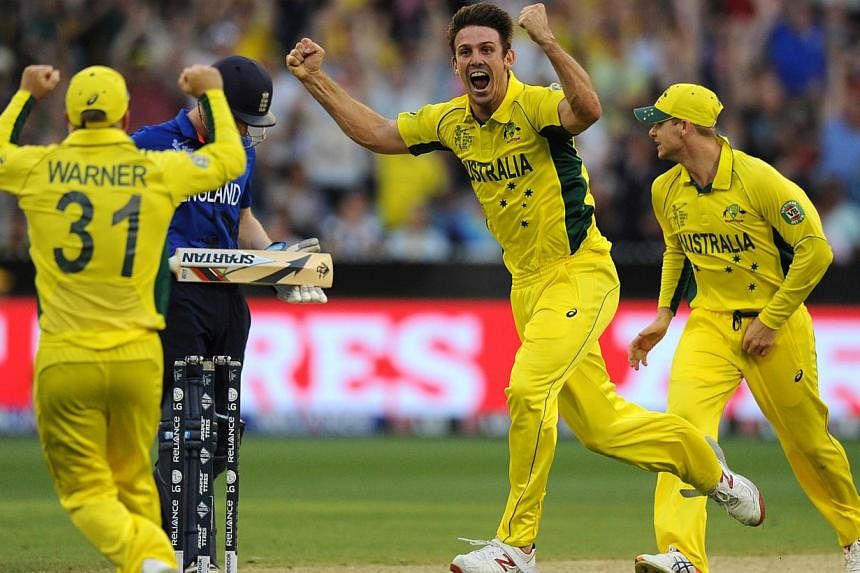Australia's Mitchell Marsh (centre) celebrates the wicket of England's Joe Root during their 2015 Cricket World Cup match at the Melbourne Cricket Ground (MCG) on Feb 14, 2015. -- PHOTO: AFP