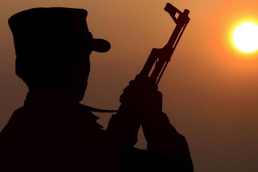 A file picture showing a Shan State Army soldier (SSA) silhouetted against the sun. The country's national army launched fresh air atrikes against rebels in the north on Feb 14, 2015.&nbsp;-- PHOTO: EPA