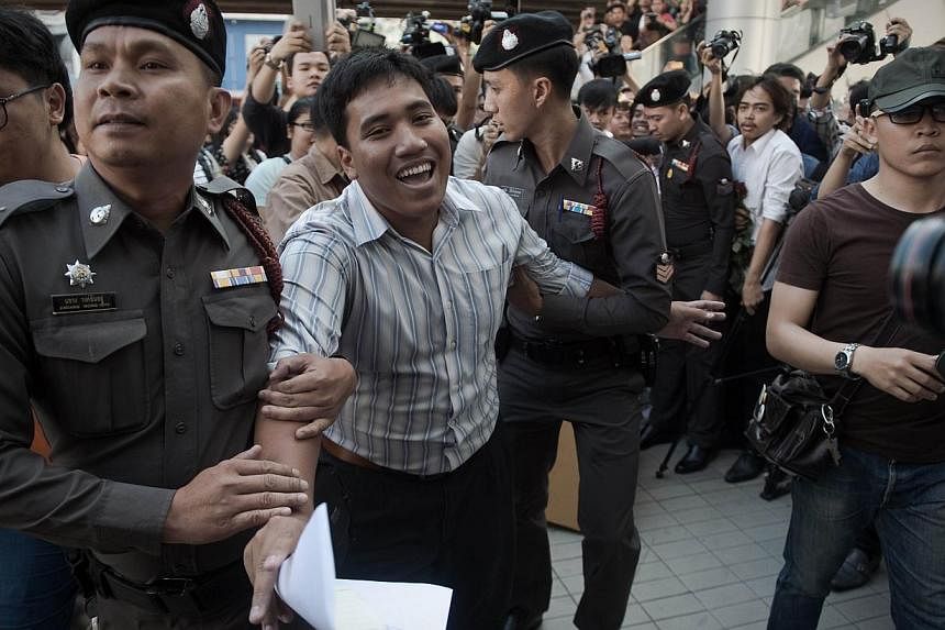 A demonstrator (centre) is arrested by police officers as he was making a speech outside the Art and Cultural centre during a rally in Bangkok on Feb 14, 2015.&nbsp;-- PHOTO: AFP