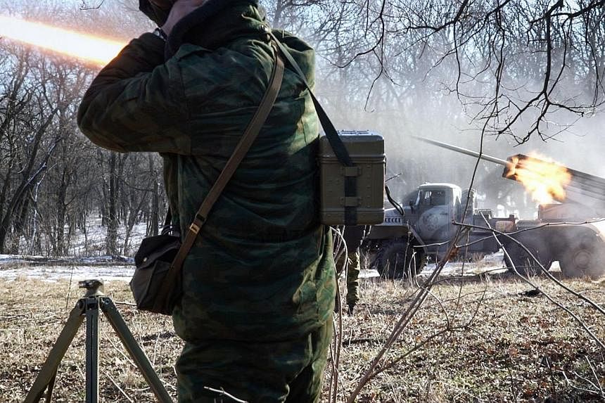 Pro-Russian rebels stationed in the eastern Ukrainian city of Gorlivka, Donetsk region, launching missiles from a Grad launch vehicle toward a position of the Ukrainian forces in Debaltseve, about 35km east of Gorlivka, on Feb 13, 2015. -- PHOTO: AFP