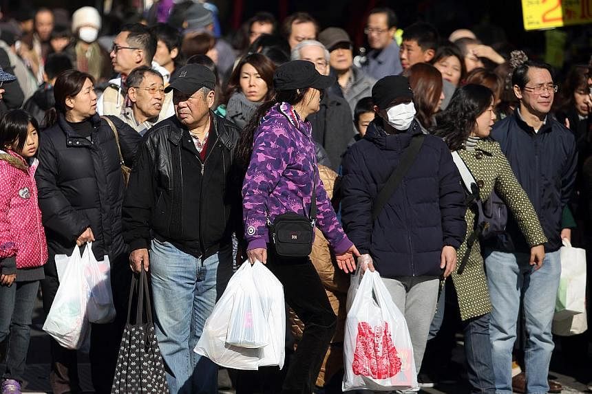 Shoppers waiting to cross a road in the Ameya Yokocho shopping district of Tokyo, Japan, on Dec 30, 2014. Japan's economy rebounded from recession to grow an annualised 2.2 per cent in the final quarter of last year, but the expansion was smaller tha