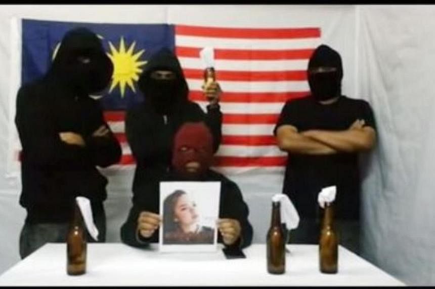 A screenshot of the video which depicted four masked men issuing a warning that they would "blow up fireworks" at a courthouse on Wednesday. -- PHOTO:&nbsp;&nbsp;THE STAR/ASIA NEWS NETWORK