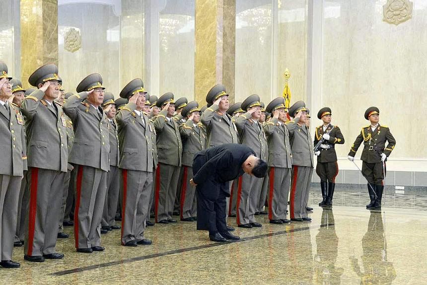 A picture released by the Rodong Sinmun, the newspaper of North Korea's ruling Workers Party, shows North Korean leader Kim Jong Un (centre) bowing to the embalmed corpse of his father Kim Jong Il, at the Kumsusan Palace of the Sun in Pyongyang, Nort