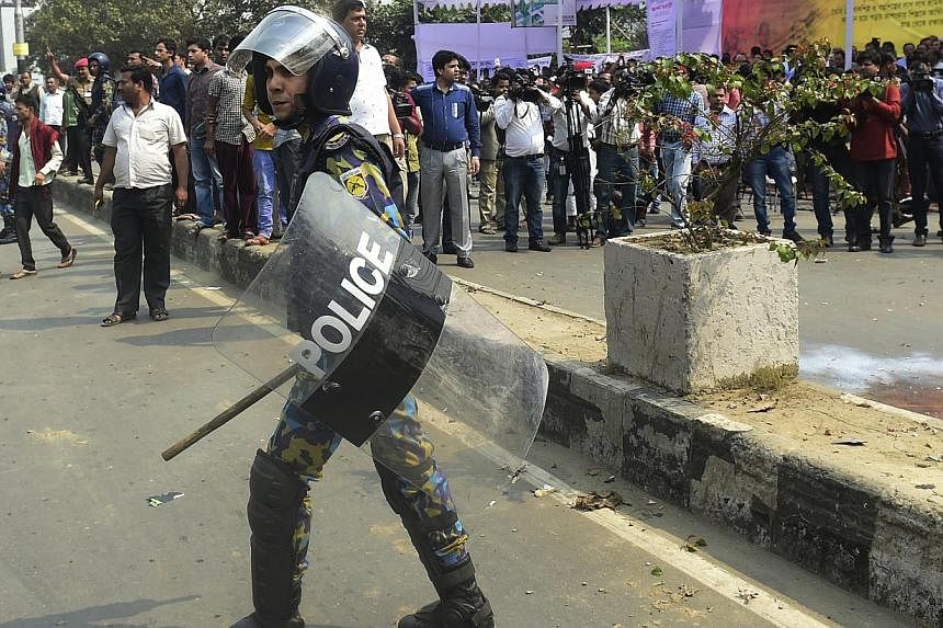 A Bangladeshi policeman looks on following a crude bomb explosion where a token hunger-strike against a nationwide strike called by the Bangladesh Nationalist Party (BNP)-led alliance is continuing in Dhaka on Feb 14, 2015. More than 80 people have b
