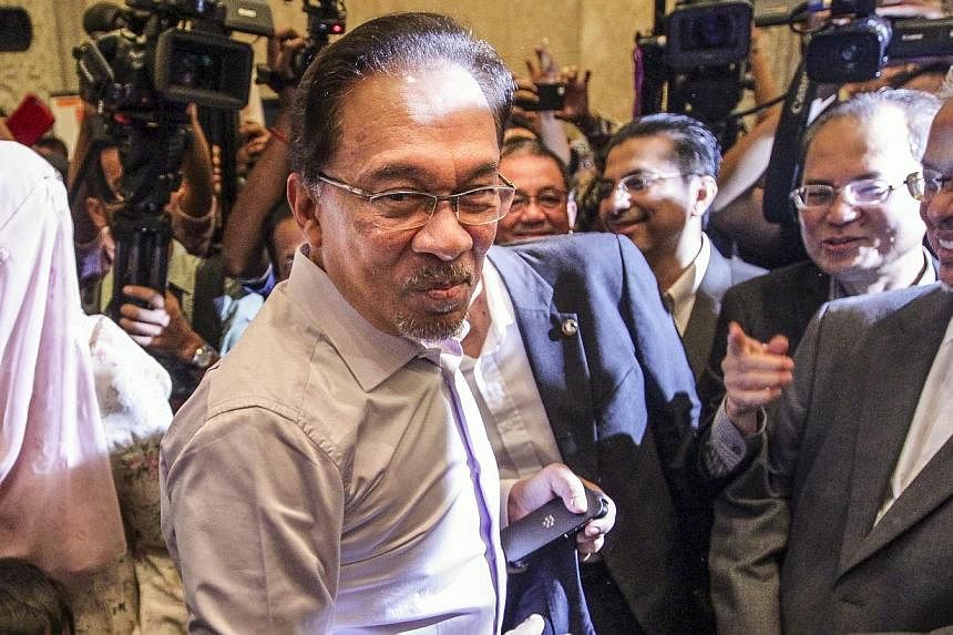 Malaysian opposition leader Anwar Ibrahim (centre) arriving at the Palace of Justice in Putrajaya, Malaysia on Feb 10, 2015. He is jailed in "deplorable" conditions in a small cell with only a thin foam mattress on the floor, a squat toilet and a buc