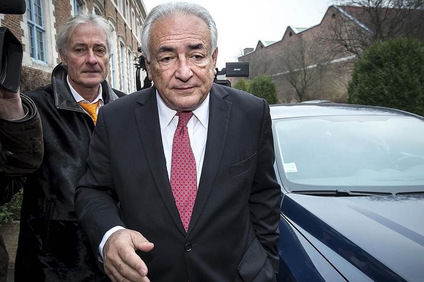 Former IMF chief Dominique Strauss-Kahn on his way to the Lille courthouse to attend a trial where he is charged alongside 13 others for "aggravated pimping" on Feb 12, 2015. -- PHOTO: AFP