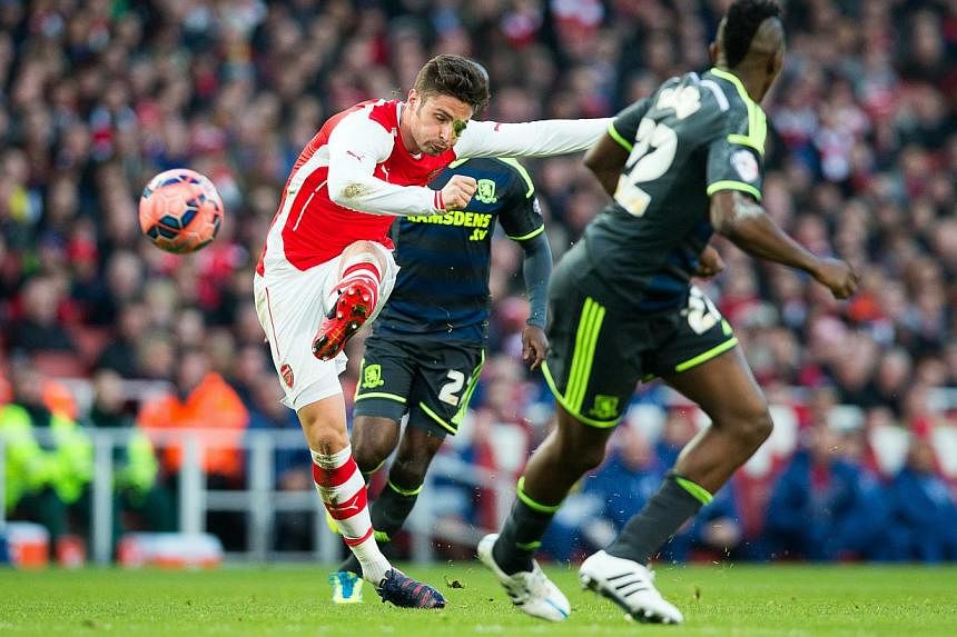 Arsenal's French striker Olivier Giroud (left) in action during the English FA Cup fifth round soccer match between Arsenal FC and Middlesbrough FC in London on Sunday. -- PHOTO: EPA