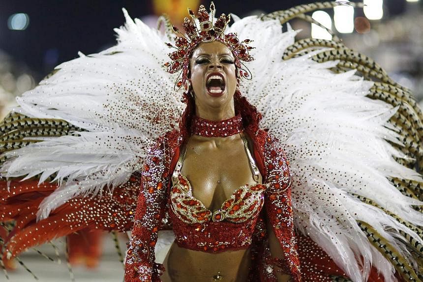 A reveller from the Alegria da Zona Sul samba school takes part in the annual Carnival parade in Rio de Janeiro's Sambadrome on Saturday. -- PHOTO: REUTERS