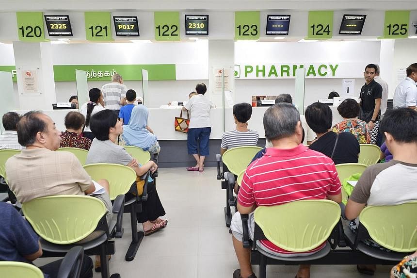 Patients waiting for their medicine at the pharmacy at Tampines Polyclinic. -- PHOTO: ST FILE