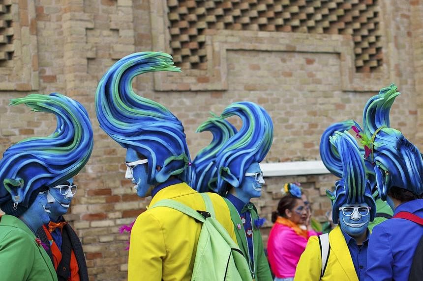 Men in fancy costumes chat during the Carnival of Cadiz, one of the best-known carnivals in Spain, Feb 15, 2015. The whole city participates in the carnival for more than two weeks each year which will run until Feb 22 this year. -- PHOTO: REUTERS