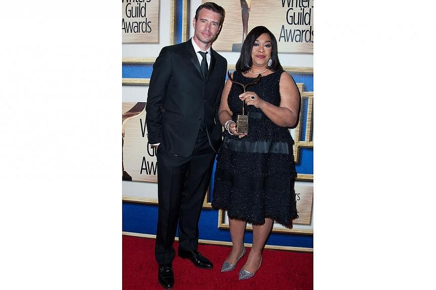 Actor Scott Foley (left) and writer Shonda Rhimes pose in the press room at the 2015 Writers Guild Awards in Los Angeles on Feb 14, 2015, after Rhimes received the Paddy Chayefsky Laurel Award for Television Writing Achievement. -- PHOTO: AFP