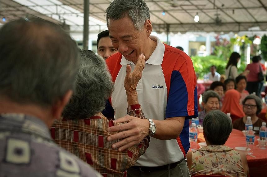 PM Lee Hsien Loong meeting elderly residents at the Teck Ghee Division Hongbao Presentation Ceremony 2015. As generations of family members gather for their Chinese New Year reunion feast on Wednesday, Mr Lee urged Singaporeans not to overlook the im