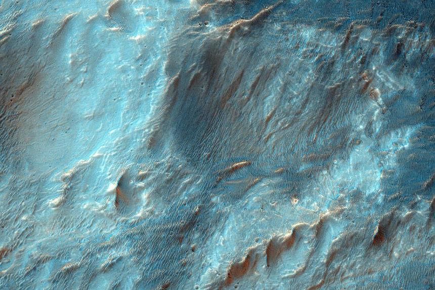 This NASA image obtained Feb 12 shows Bigbee, a 21 kilometre-diameter impact crater located on the northern rim of Holden crater in southern Margaritifer Terra, a region on Mars that is well known for its long record of water-rich activity. --PHOTO: 