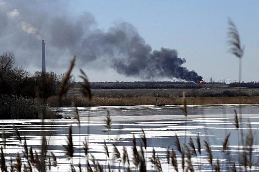 A view of an explosion is seen from the shelled gas pipe near the power station, not far from Debaltseve of Donetsk area, Ukraine on Monday. Separatist rebels in eastern Ukraine say that they have taken large parts of Debaltseve, the strategic rail h