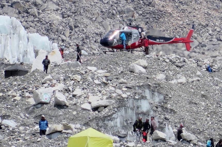 In this photograph taken on April 18, 2014, a Nepalese rescue helicopeter lands at Everest Base Camp during rescue efforts following an avalanche that killed sixteen Nepalese sherpas in the Khumbu icefall at the base of Mount Everest.&nbsp;-- PHOTO: 