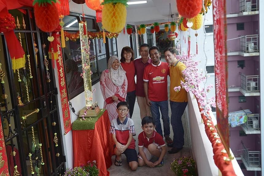 When Mr Pang Wei Ling (centre) first started his household decorations 13 years ago, they consisted of simple items like wall hangings and paper couplets. Today, the humble project has tripled in cost to about $300 and expanded into a massive array o