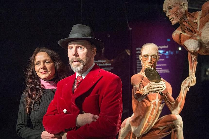 Plastination inventor Gunther von Hagens (right) and his wife Angelina Whalley stand next to a plastinates displayed at the exhibition 'Koerper Welten' (Body Worlds) at the 'Menschen Museum' (Human Being Museum) in the television tower in Berlin, Ger